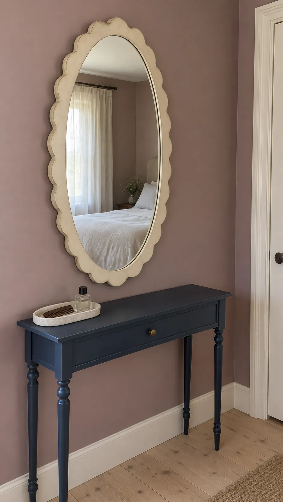 Scalloped mirror over a narrow dressing console