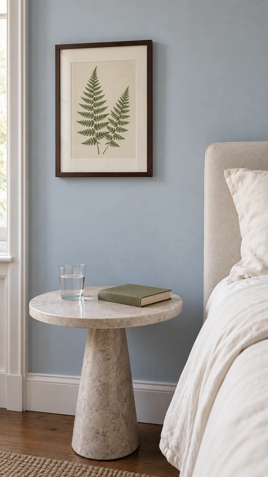 Framed botanical fern study beside a small bedroom table