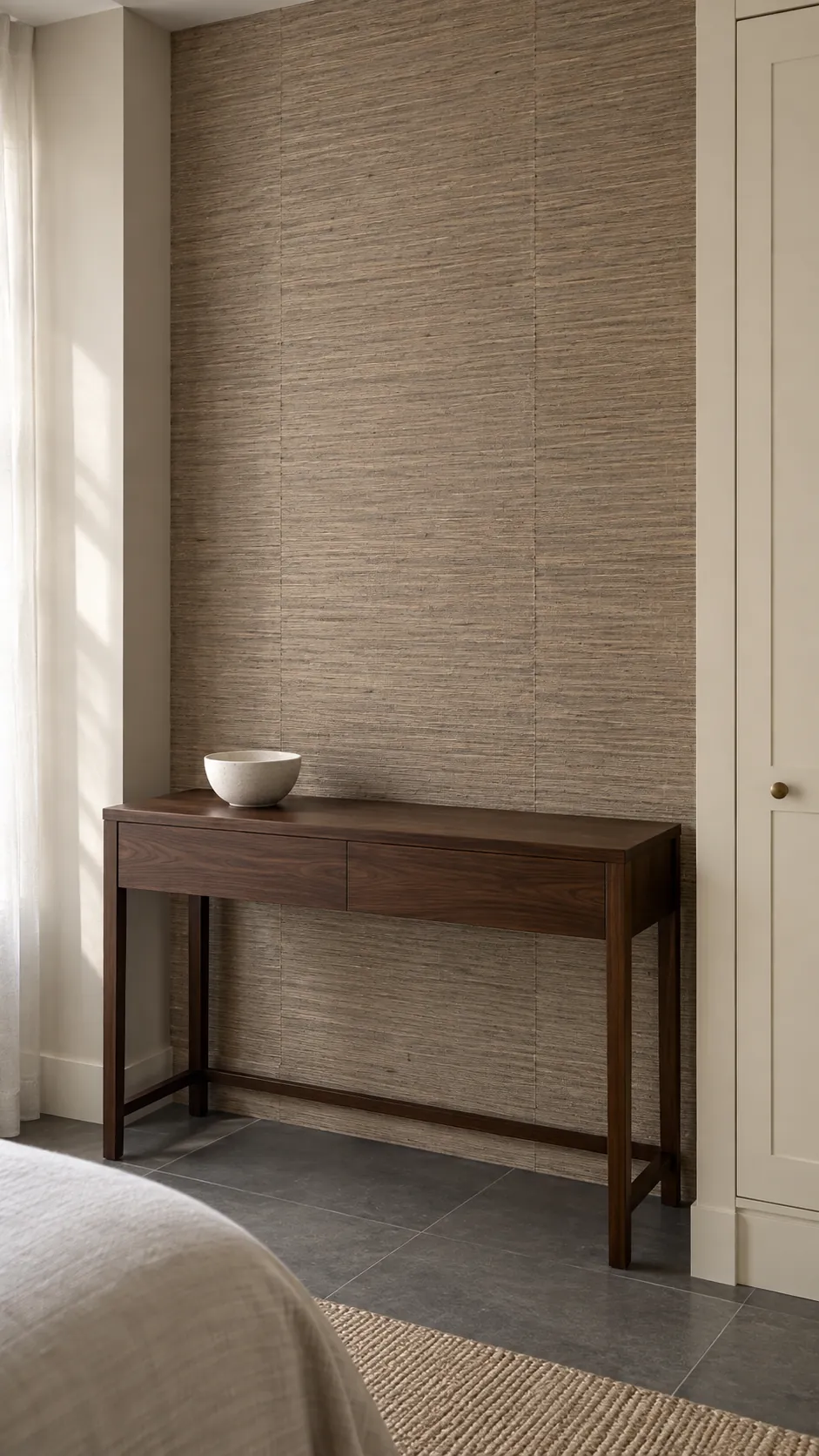 Subtle woven grasscloth on a contained bedroom dressing wall