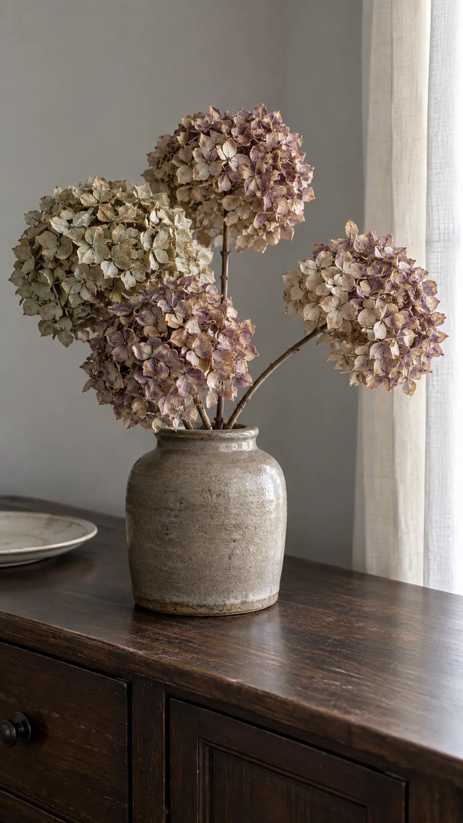 Dried hydrangeas in a stoneware crock for coastal fall decor