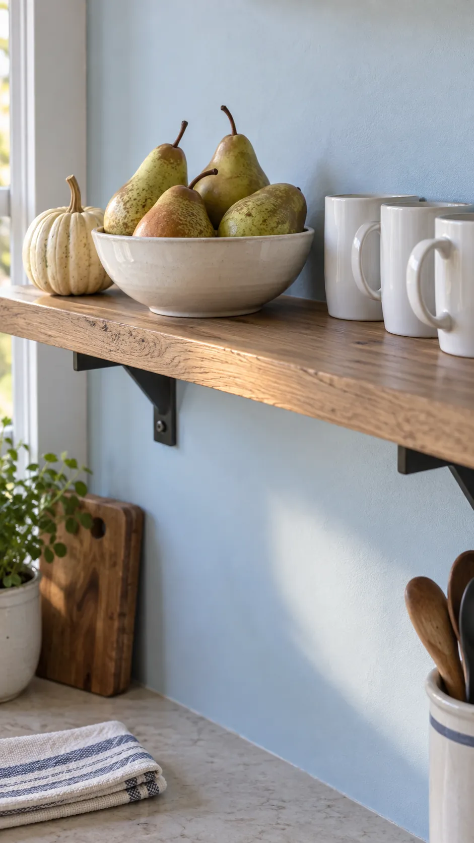 Pears and pale gourds on the kitchen shelf for coastal fall decor