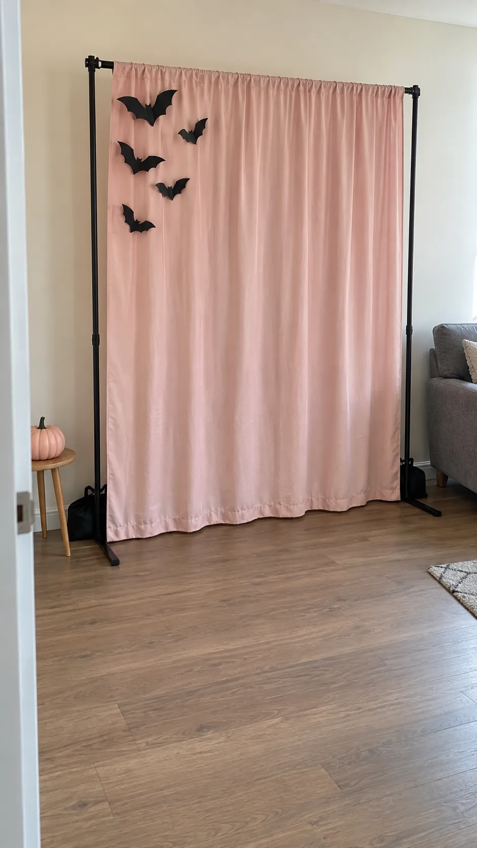 A blush curtain photo corner for a pink Halloween birthday party
