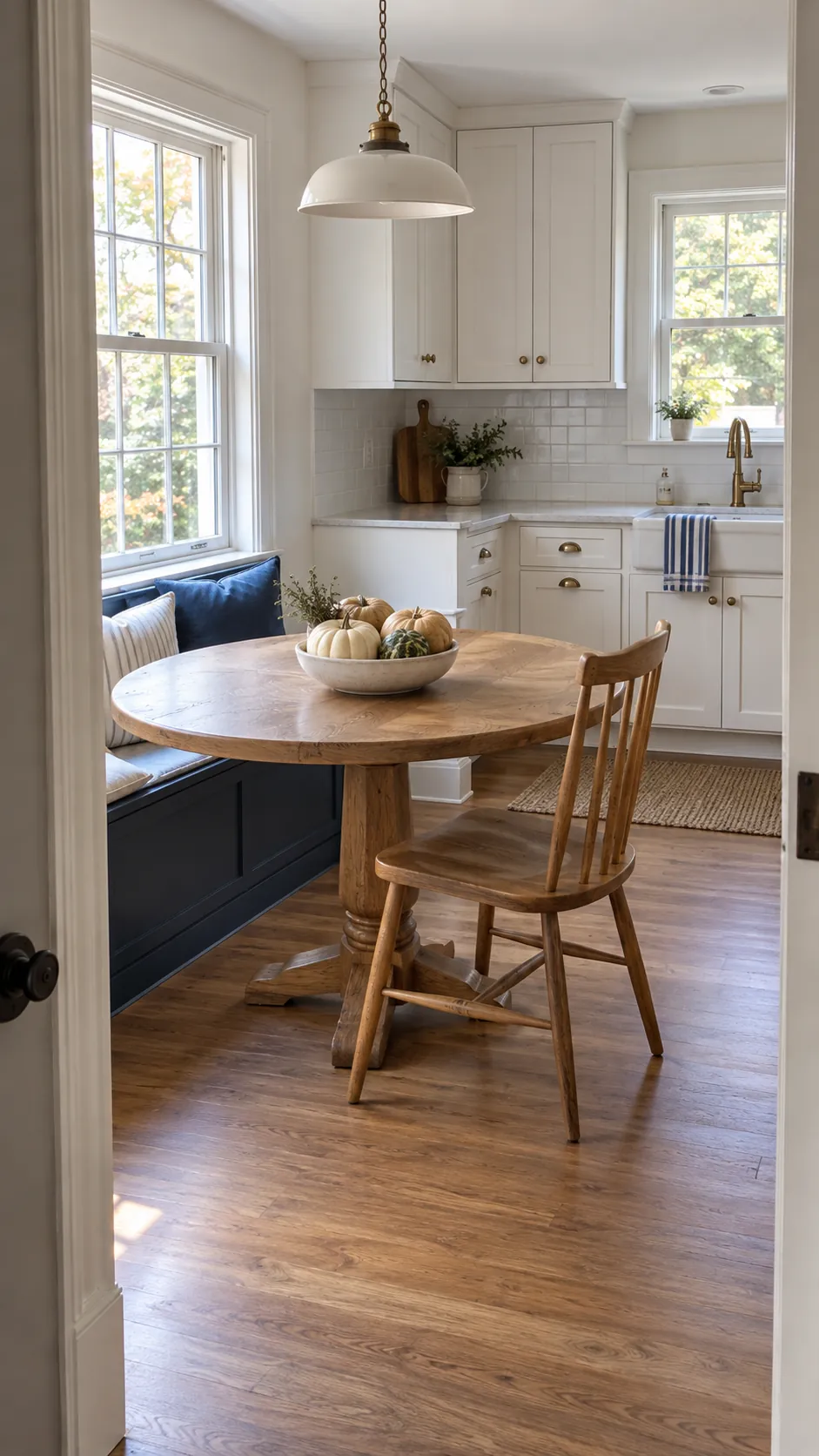 Blue and white kitchen with a low pale pumpkin centerpiece and clear counters