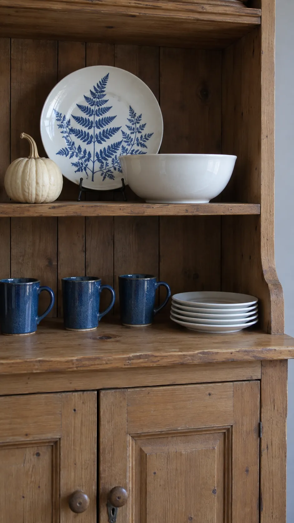 Let the hutch hold the taller seasonal pieces in a blue and white fall kitchen