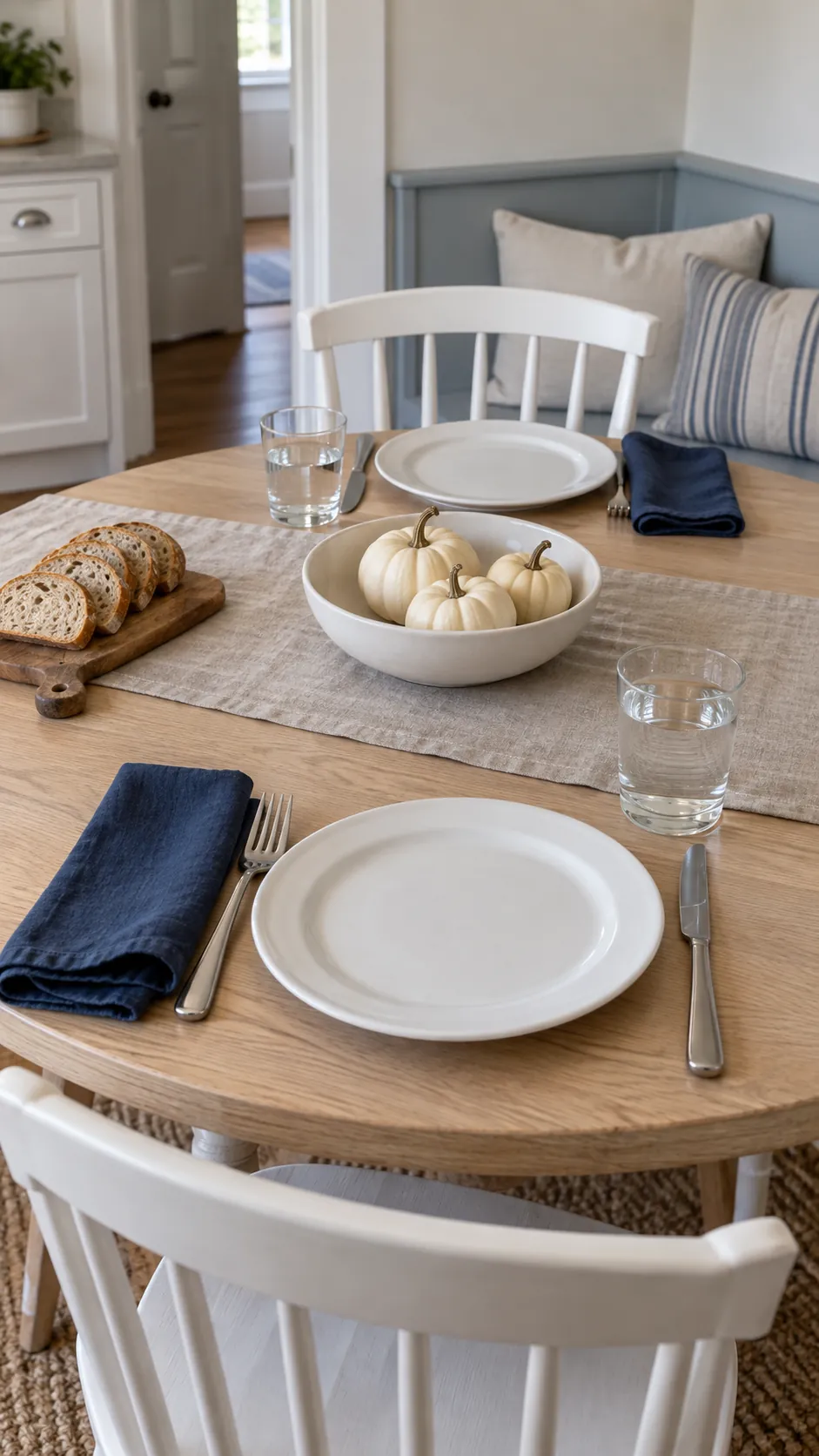 Make the table feel like fall through the place settings in a blue and white fall kitchen