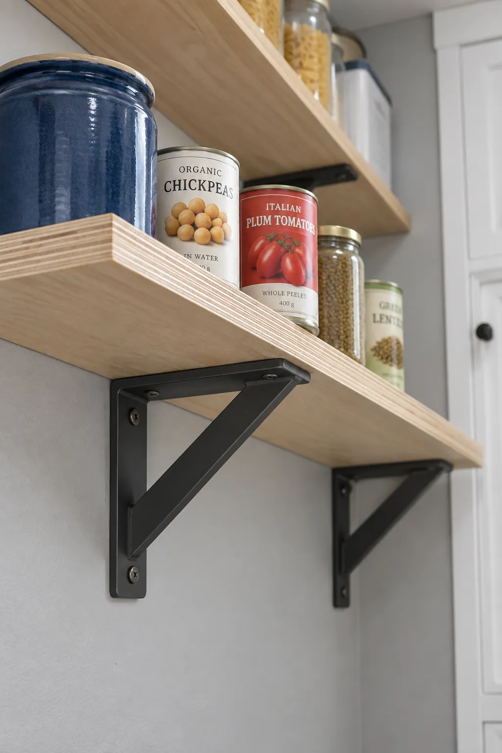 Supported pantry shelf with visible brackets and sealed wood edges