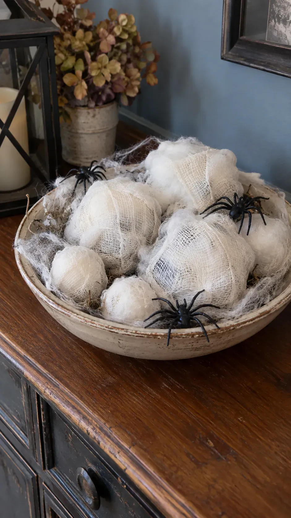 Cheap DIY Halloween decoration showing spider egg cotton bundles
