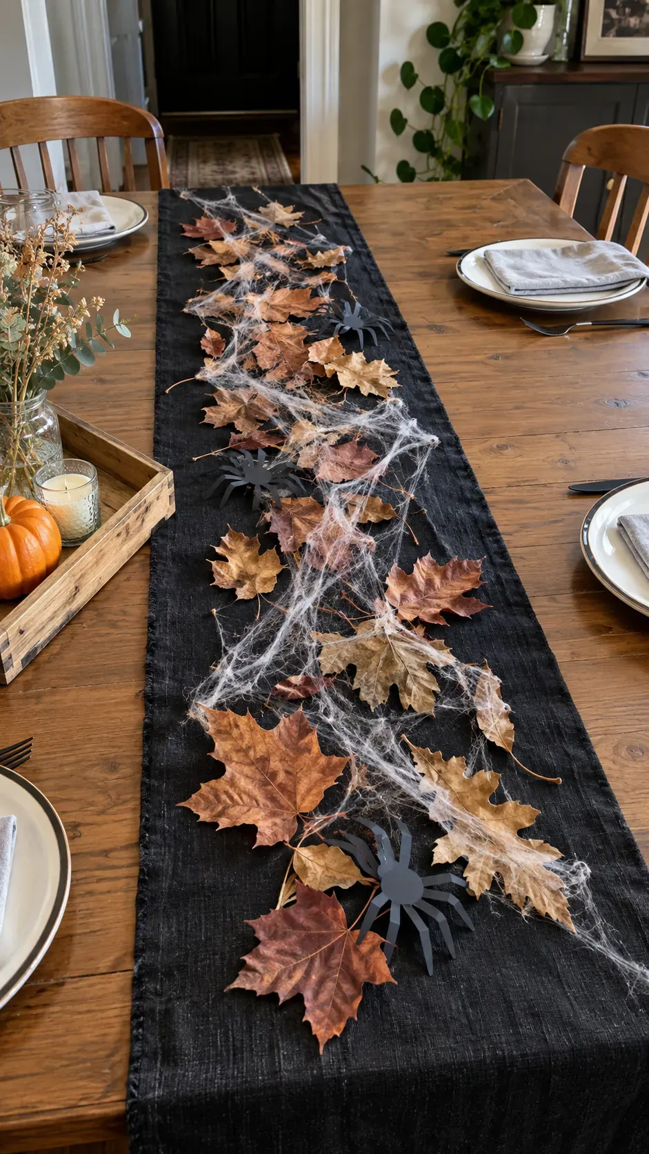 Cheap DIY Halloween decoration showing leaf and web table runner