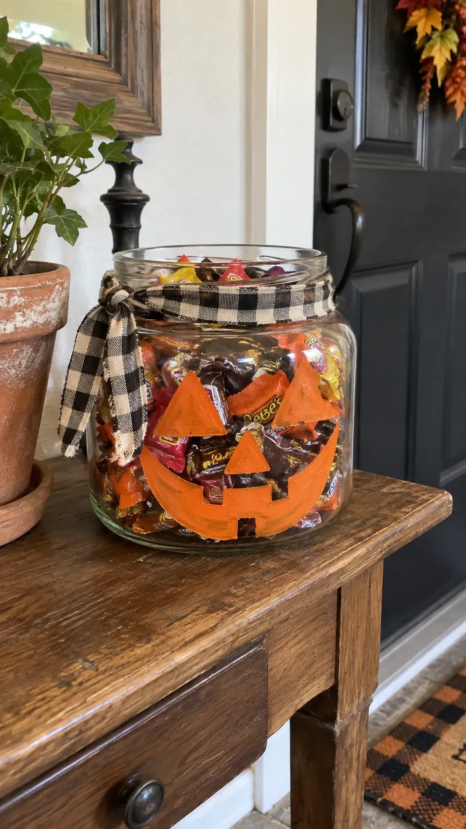 Cheap DIY Halloween decoration showing recycled jar candy bowl