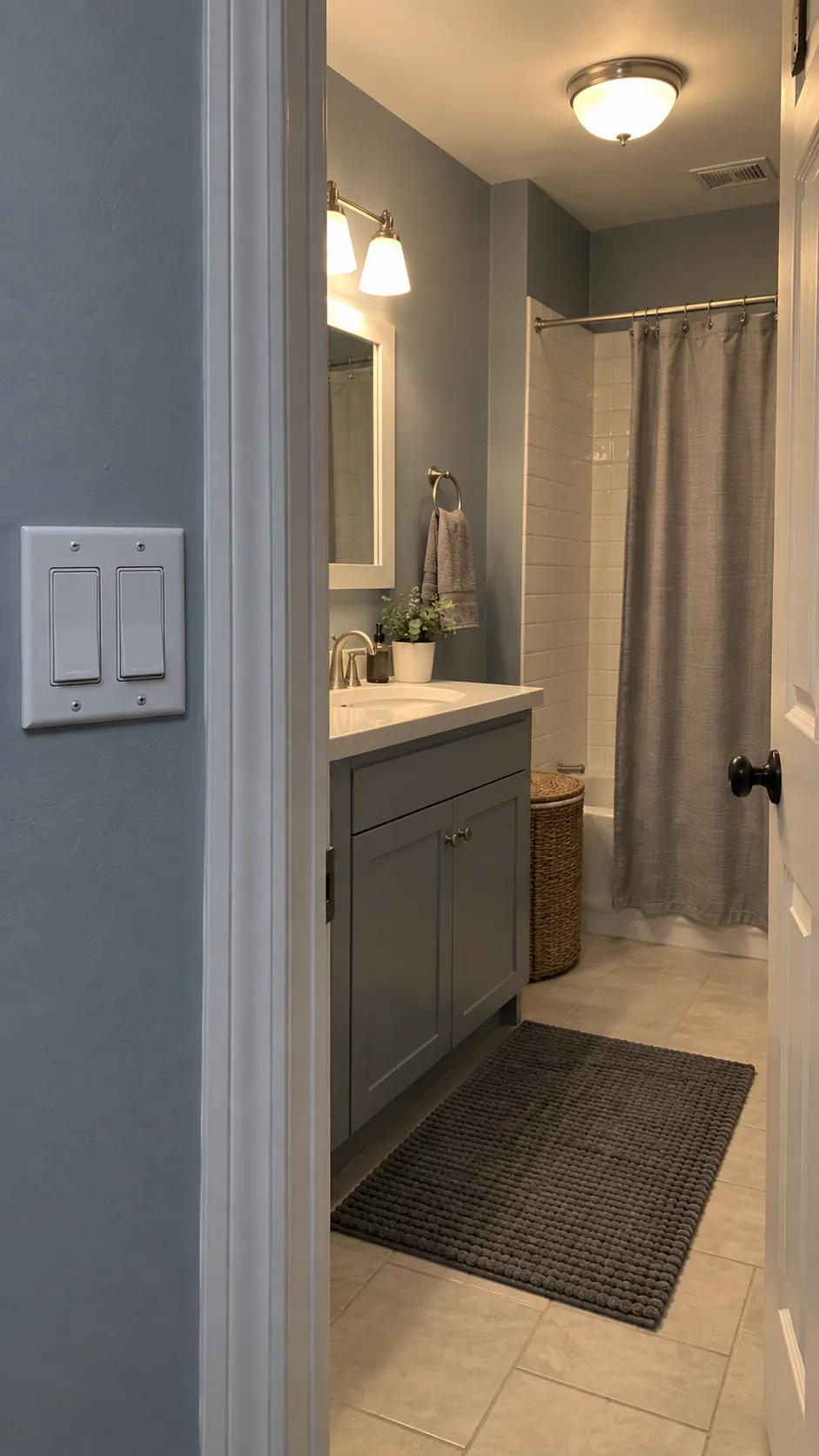Separate controls for vanity and ceiling lights in a small bathroom