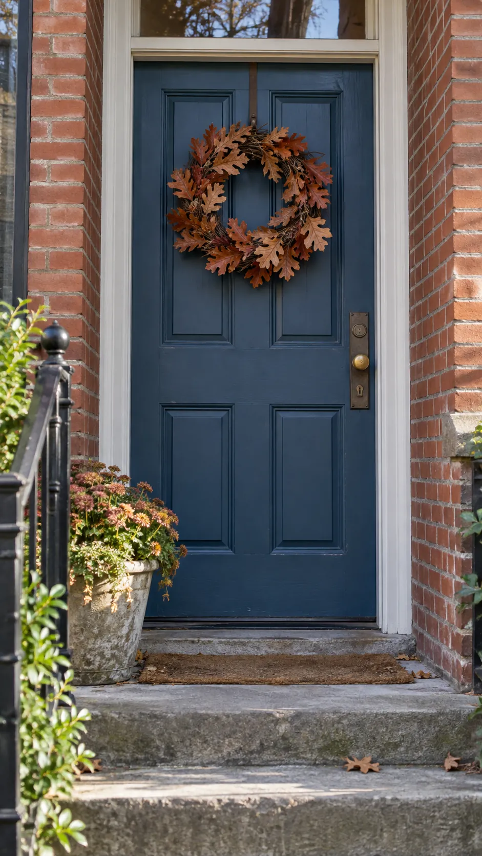 Fall front porch without pumpkins featuring oak leaf wreath on the door