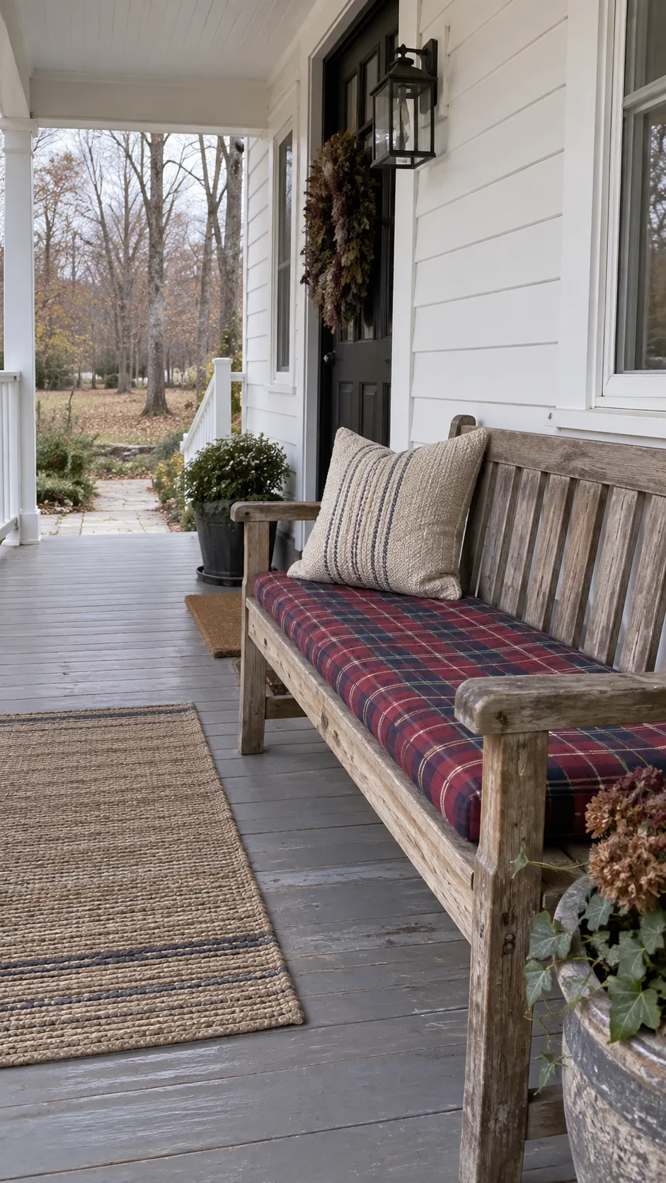 Fall front porch without pumpkins featuring plaid cushion on a covered bench