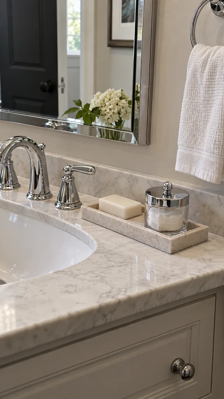 a narrow vanity tray coordinating with chrome fixtures in a powder room