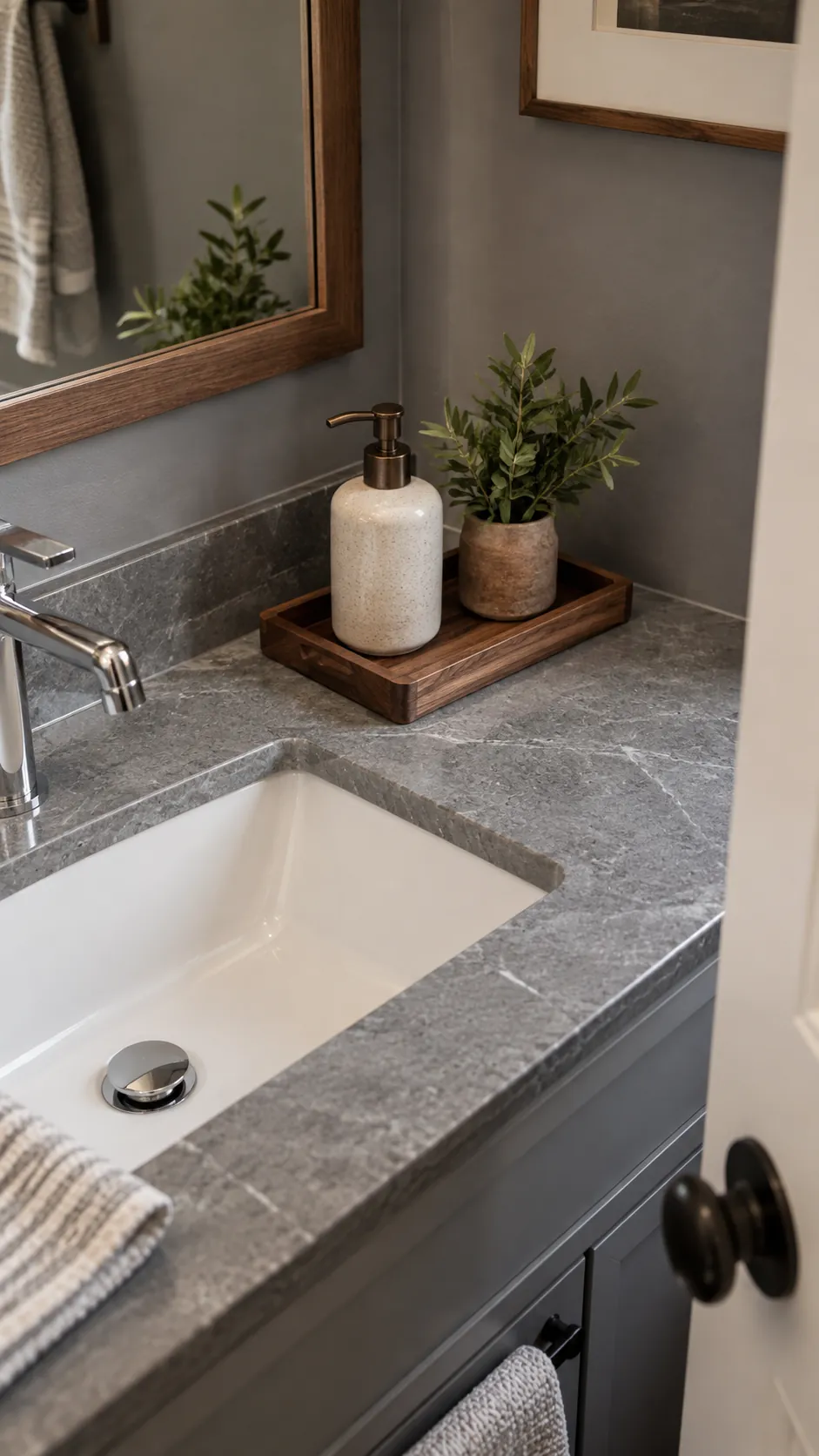 set a wood tray beside the basin in a gray powder room