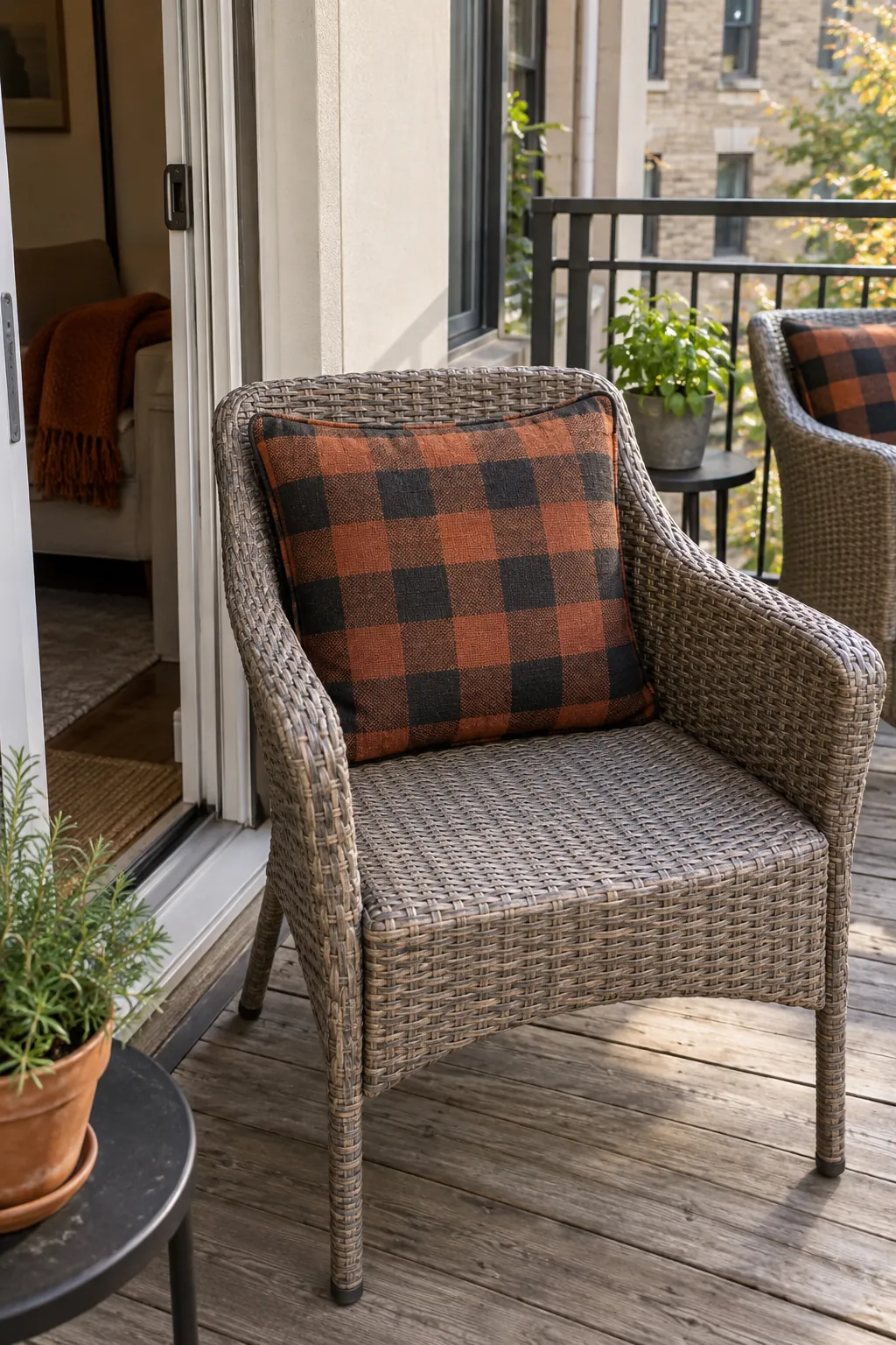 A usable balcony chair with one Halloween colored cushion cover