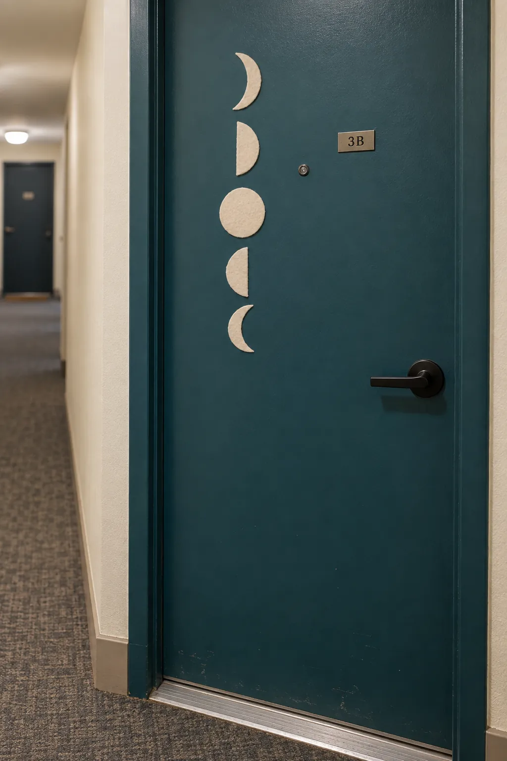 Simple moon phase shapes arranged vertically on a compact apartment door