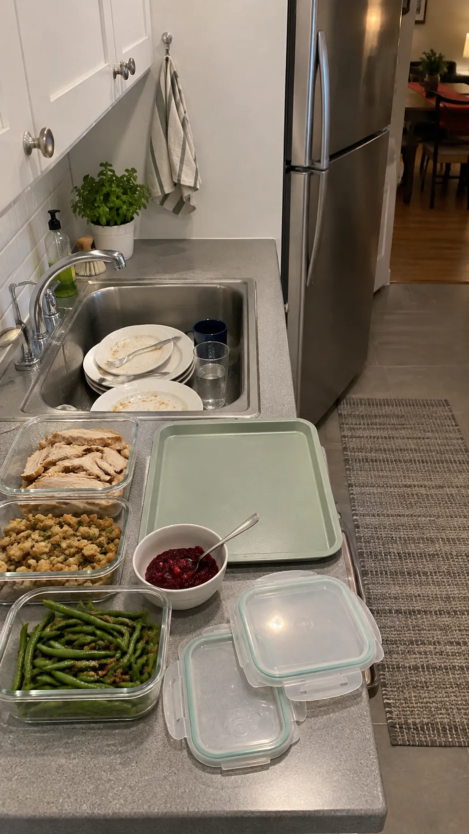 Thanksgiving leftover containers organized on a small kitchen packing surface