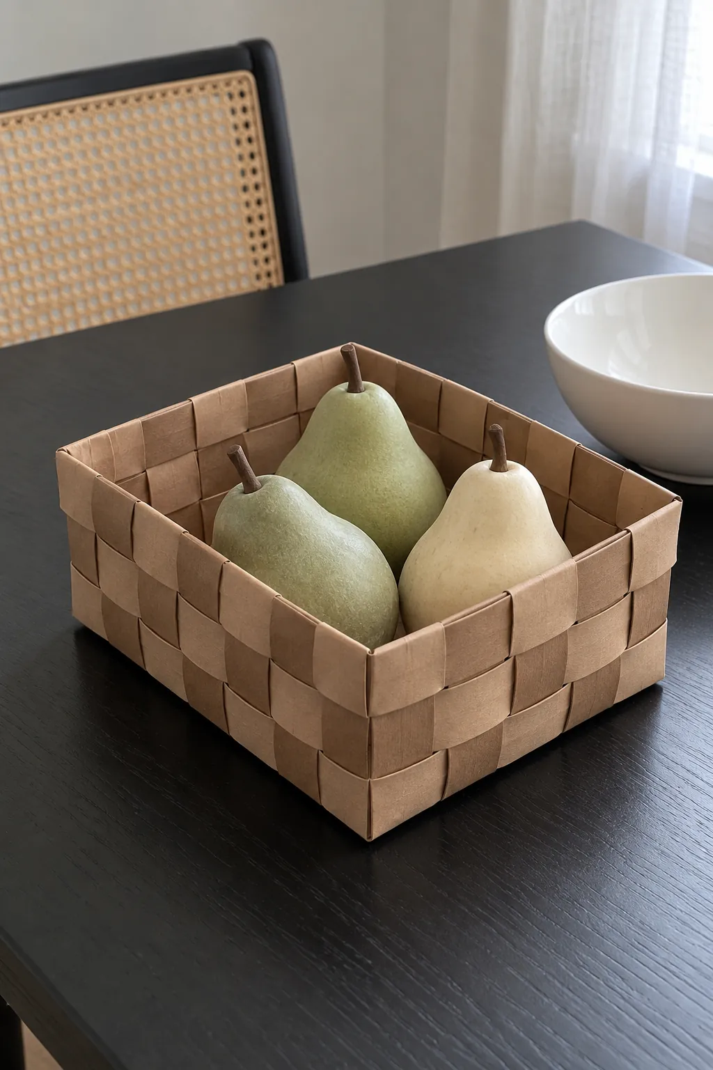 Thanksgiving table decoration with a woven paper basket of faux pears