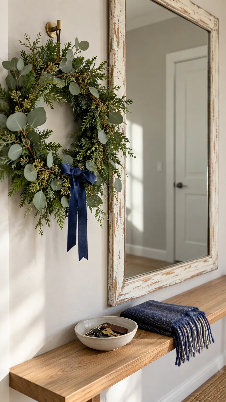 Put a wreath beside an existing mirror as a compact Christmas display in an apartment