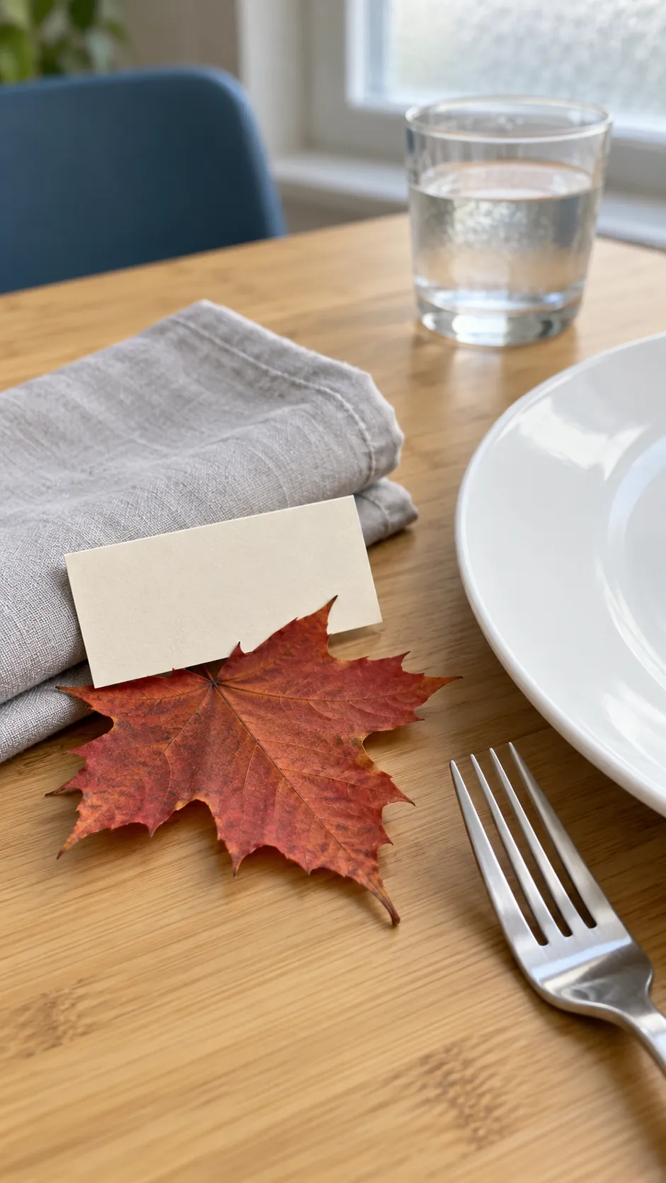 Thanksgiving tablescape featuring a single pressed leaf at each seat