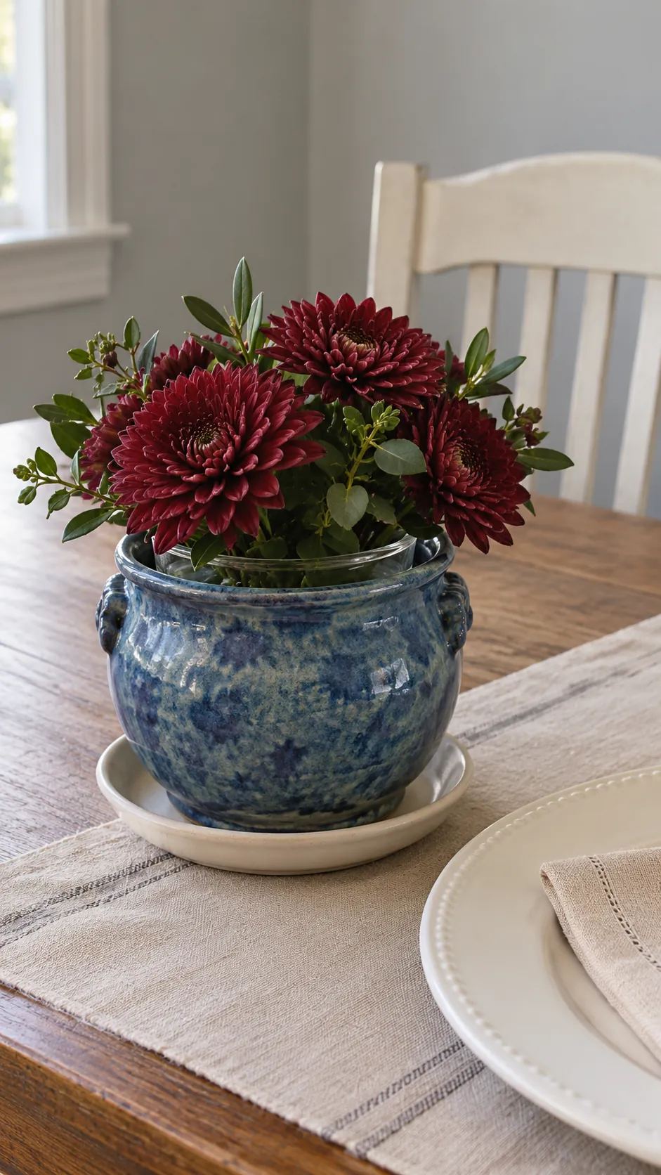 Dark Flowers in a Ceramic Vessel in a vintage Thanksgiving setting