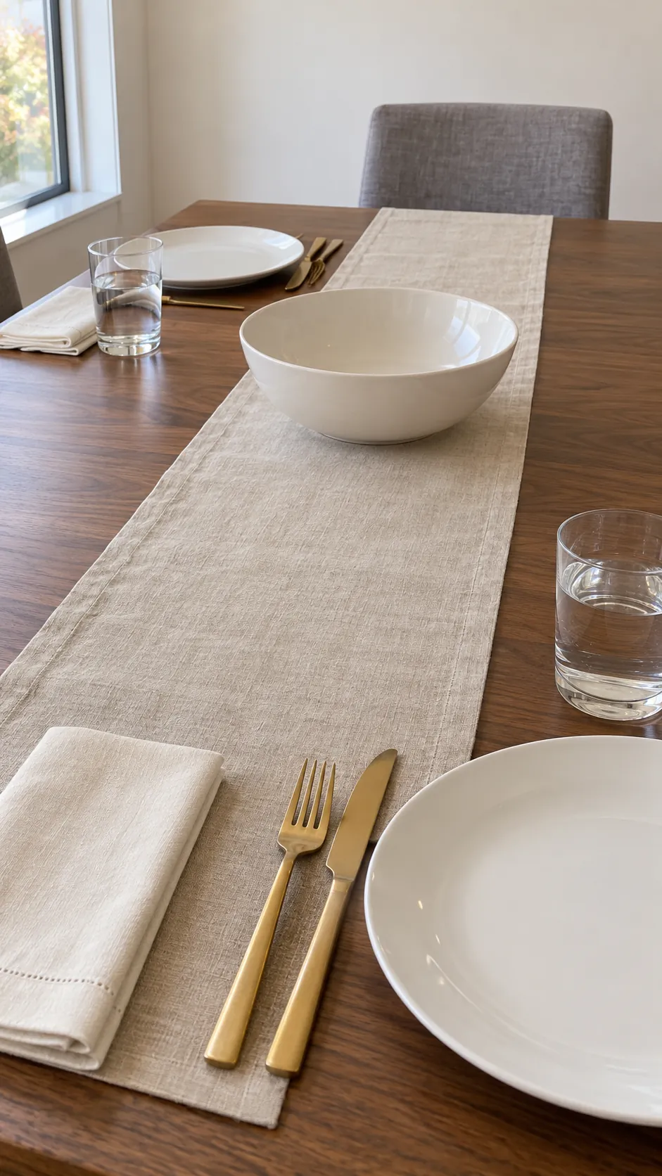 A Narrow Linen Runner with Brass Flatware at a practical modern Thanksgiving setting