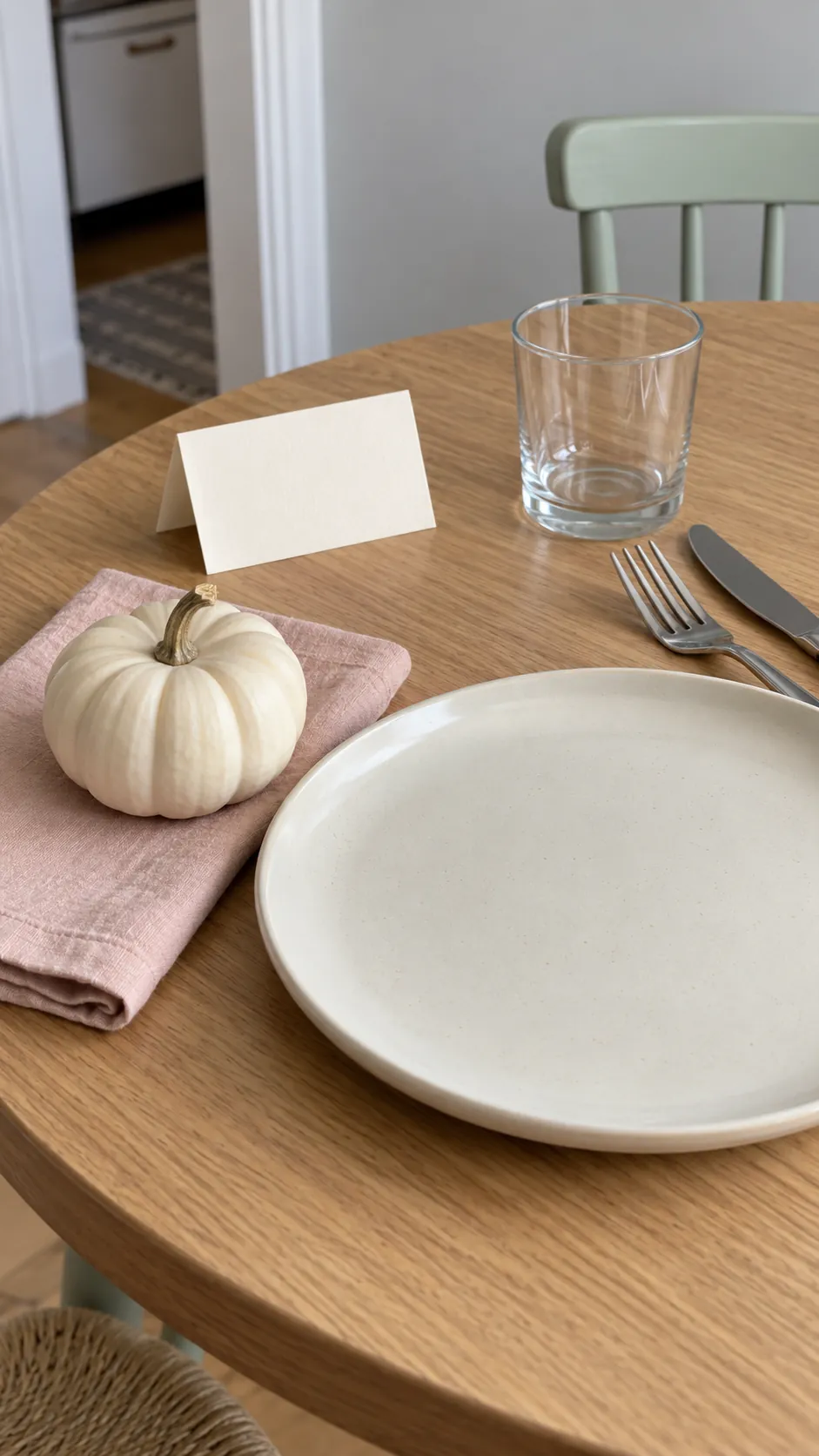 Small Pumpkins beside the Place Setting at a practical modern Thanksgiving setting