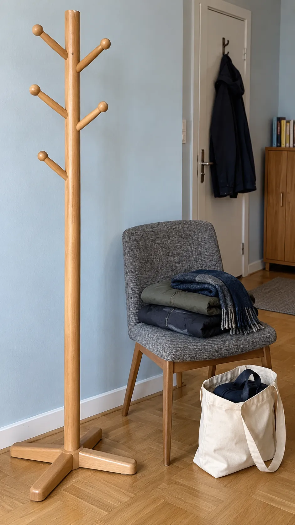 Current coats sorted beside an empty entryway rack