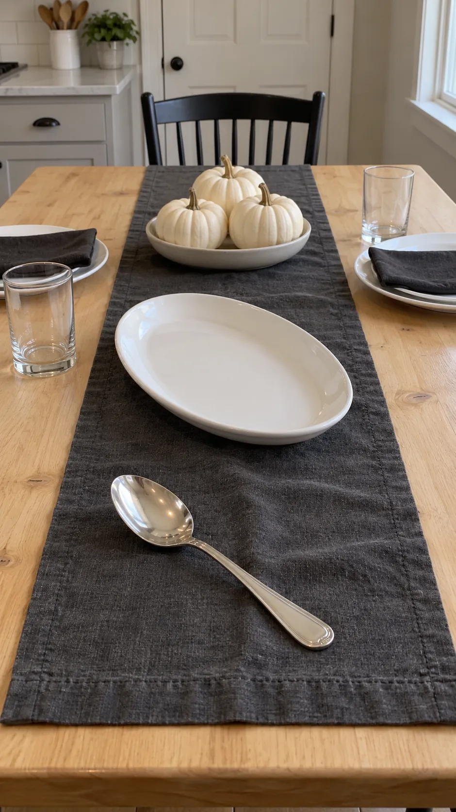 A Charcoal Runner with Small White Pumpkins for a black and white Thanksgiving table