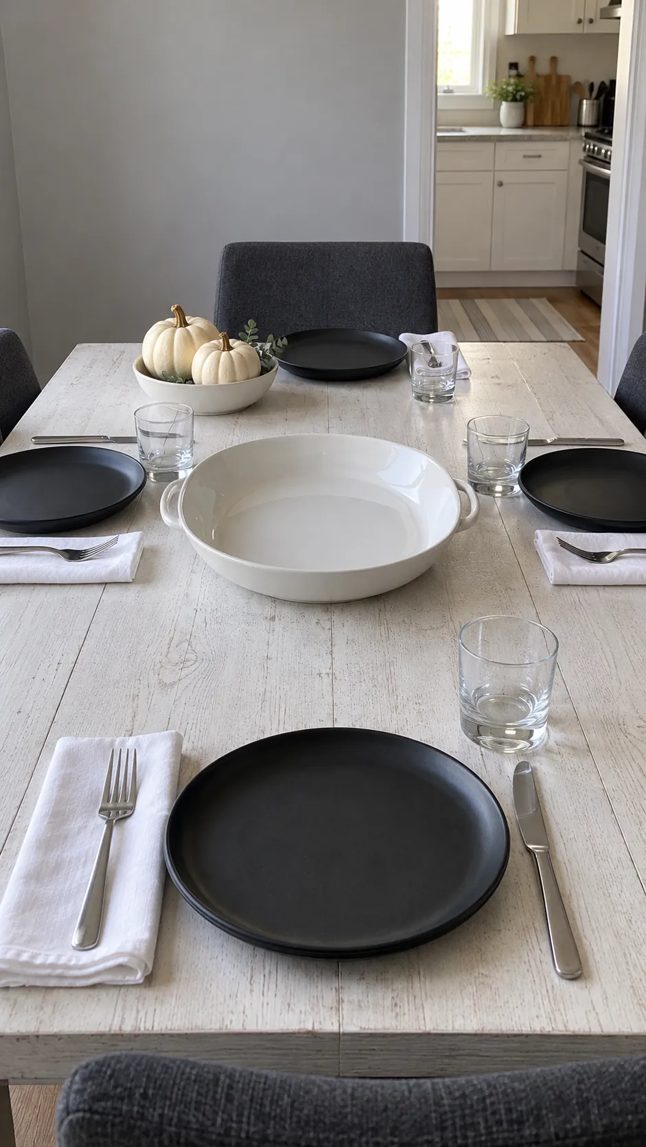 Black and white Thanksgiving table with low pumpkins and clear serving space