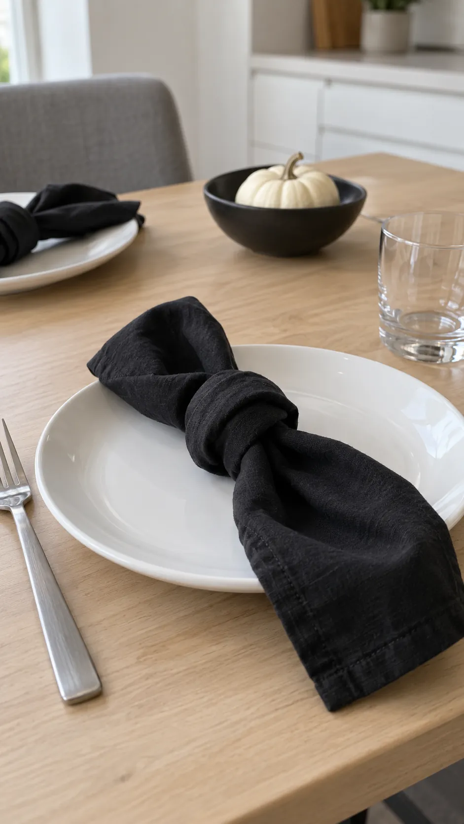 White Plates with Loose Black Napkin Knots for a black and white Thanksgiving table