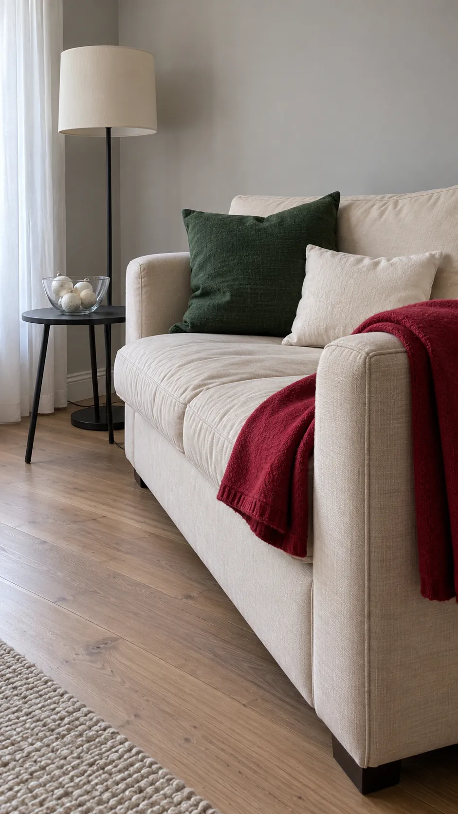 Green cushions and a red throw coordinate Christmas living room displays