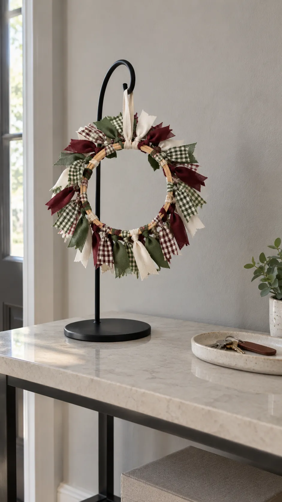 A ribbon wreath around a small hoop made with reused Christmas ribbon scraps