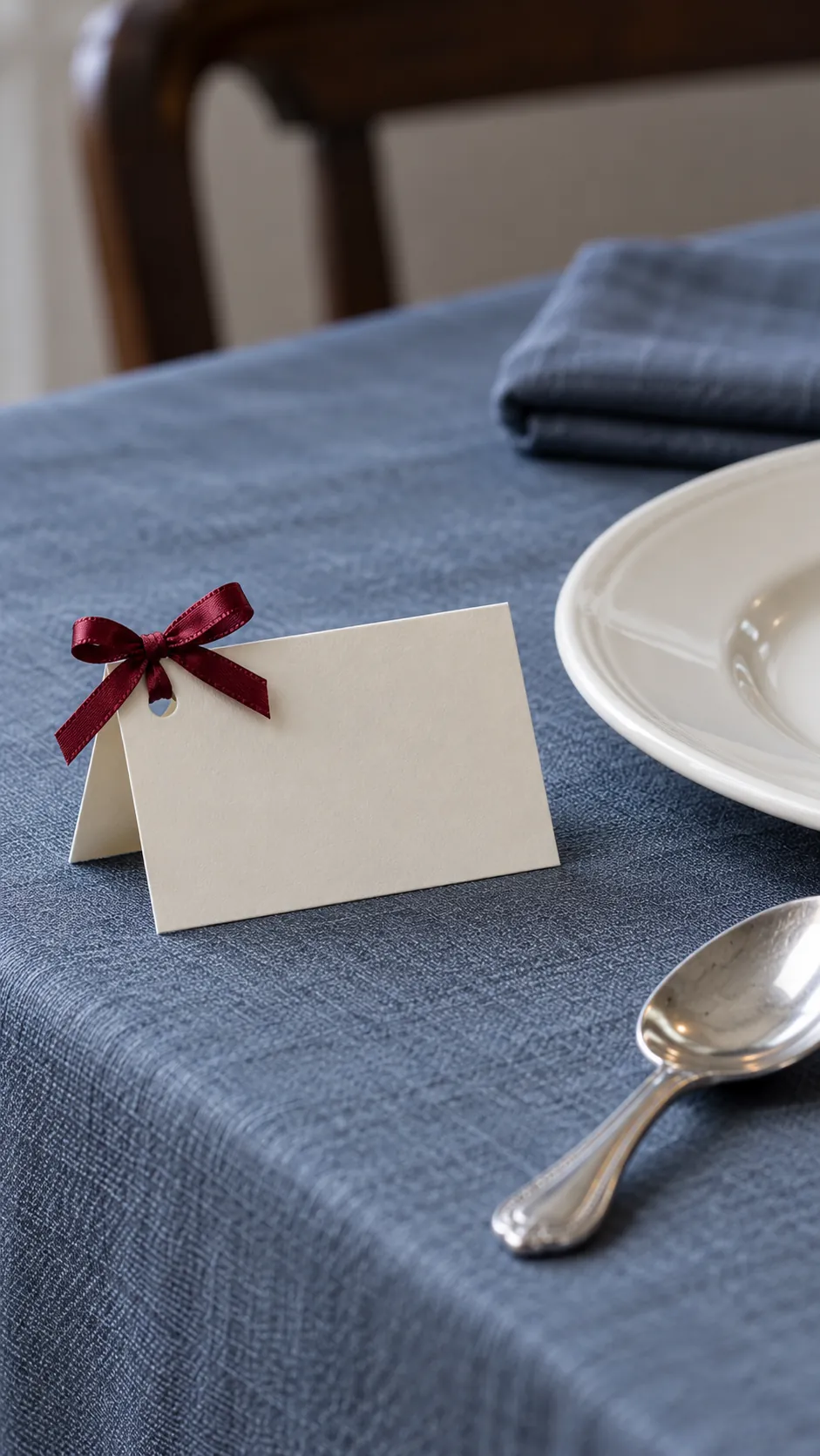 Small bows on place cards made with reused Christmas ribbon scraps