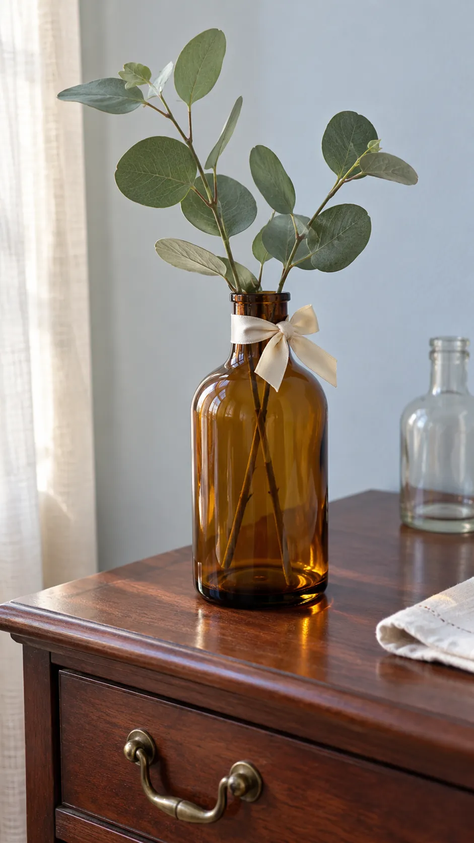 Bottle neck bows for a greenery display made with reused Christmas ribbon scraps