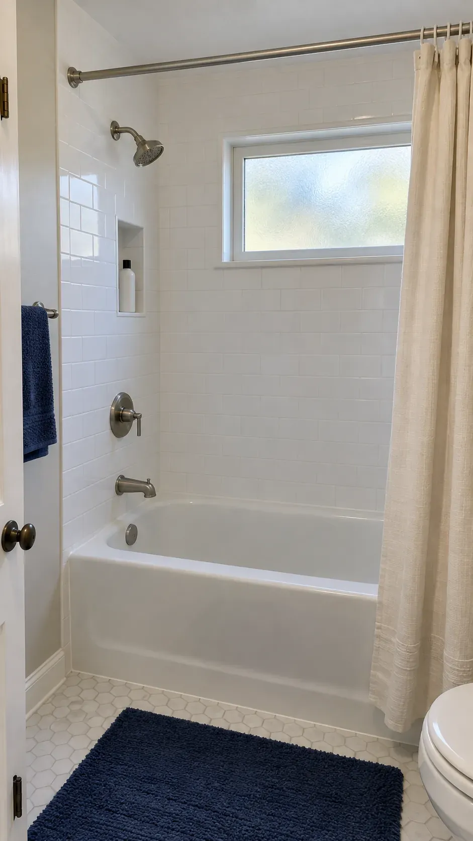 Showerhead on a solid end wall in a small bathroom