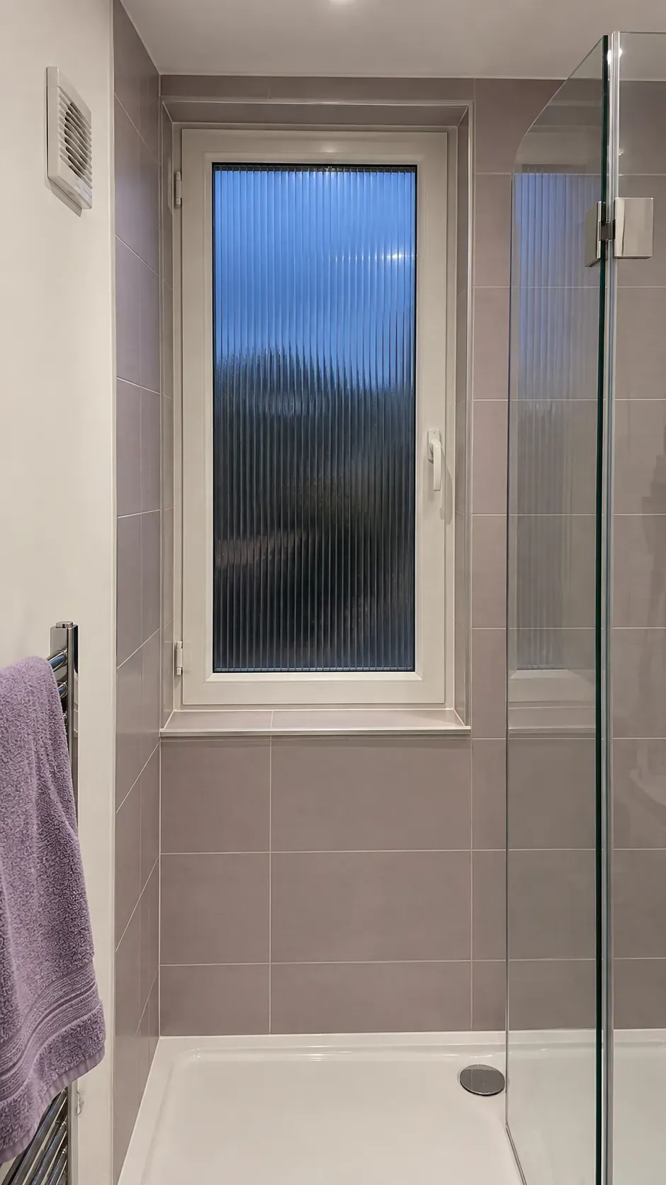 Privacy glass and reachable hardware in a small bathroom