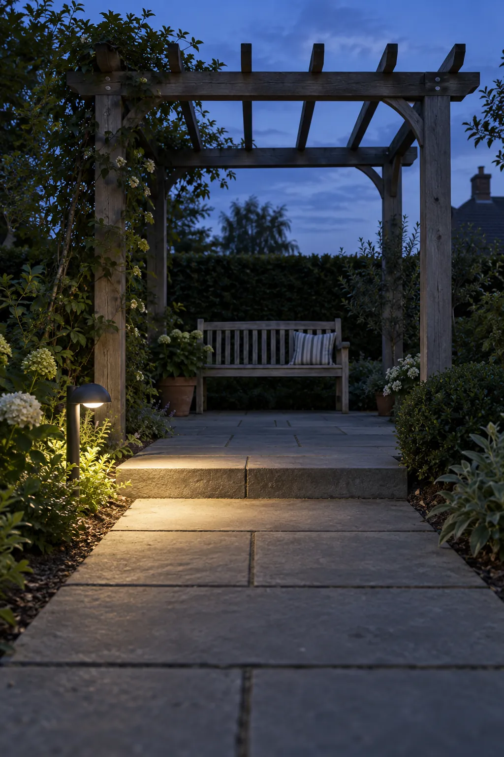 A path light at the entrance in a garden pergola setting