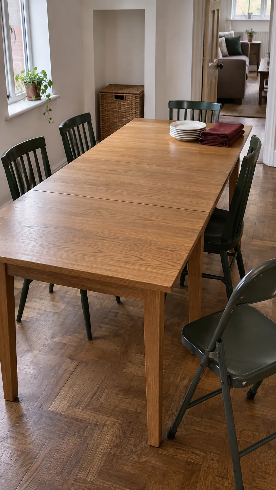 Extended dining table with a visible leaf seam and spare folding chair