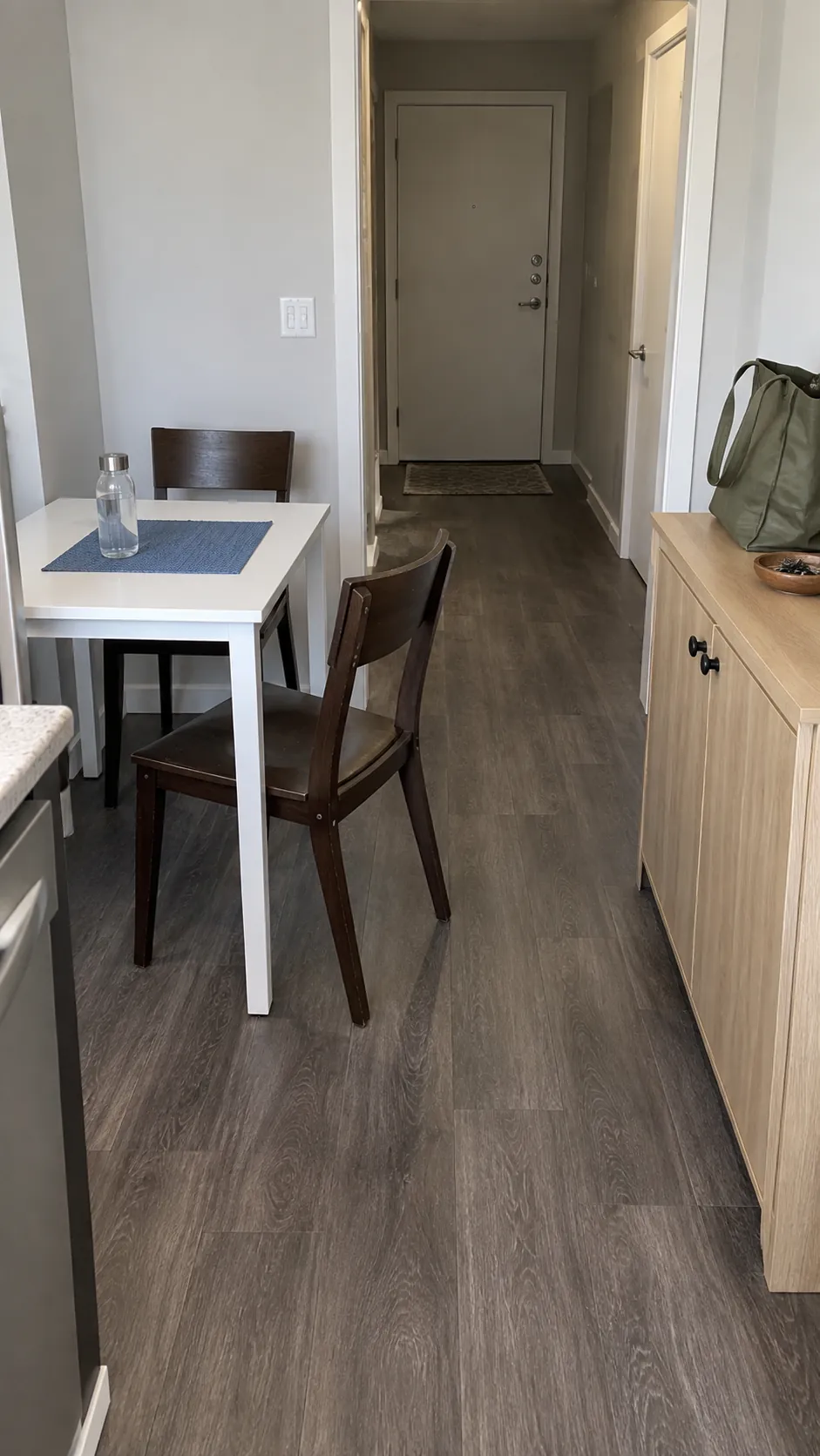 Dining zone beside a shallow cabinet and an open doorway