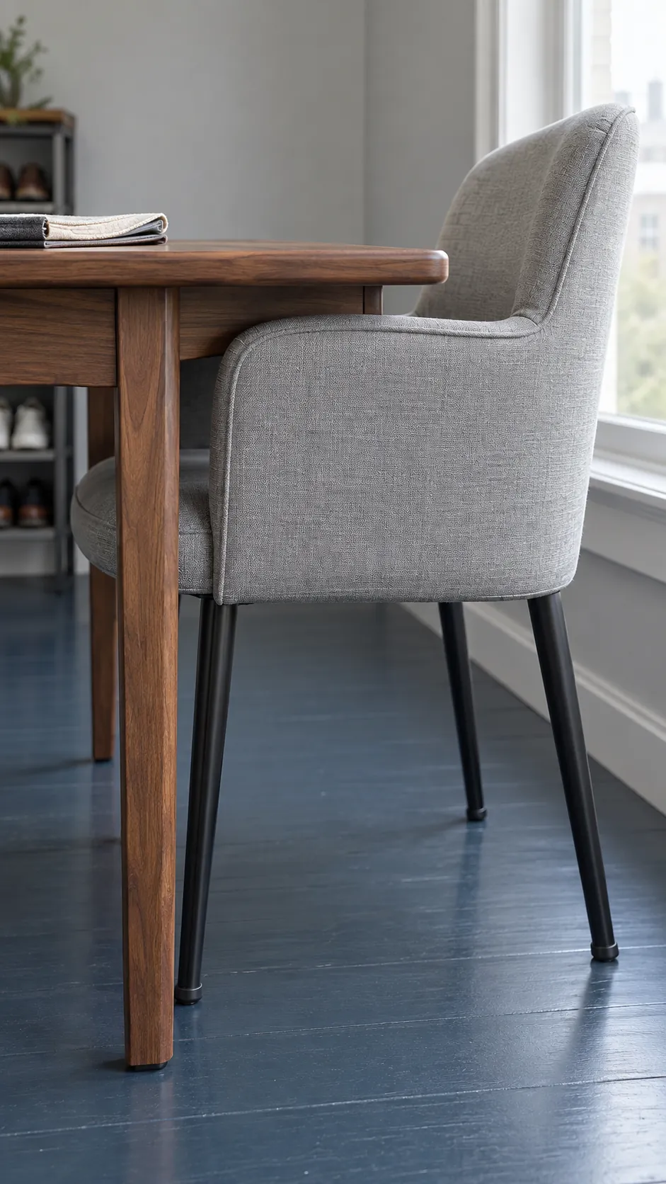 Dining chair fitted beneath a compact table showing leg and arm clearance