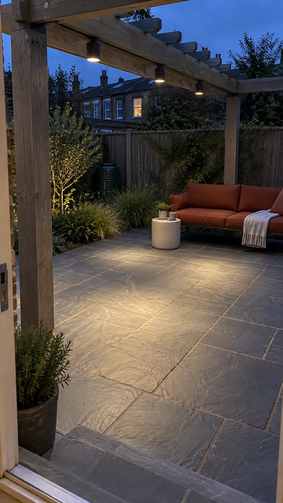 Downlights aimed toward the floor in a compact outdoor pergola setting