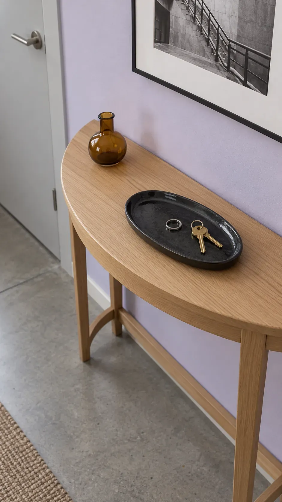 An Oval Tray on a Rounded Table on an entryway console with accessible keys