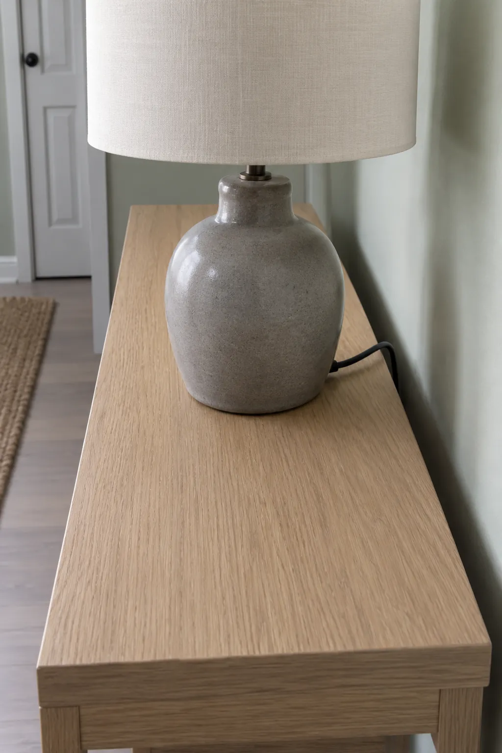 Turn the Cord Exit Toward the Wall in an entryway lamp and console arrangement
