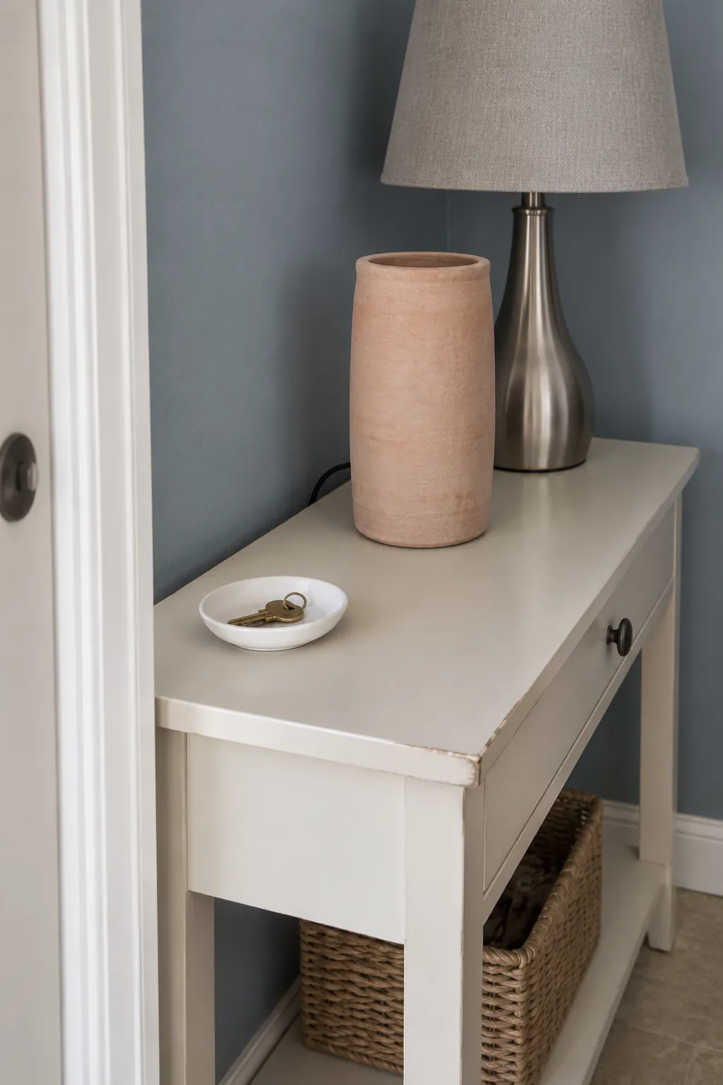 Place an Empty Vase in Front of a Short Cord Run in an entryway lamp and console arrangement