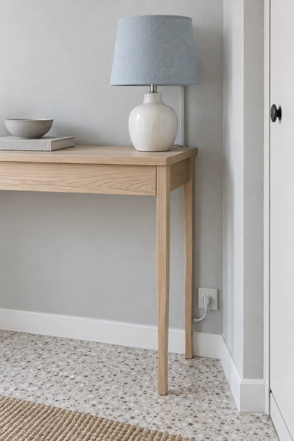 Match a Surface Cord Cover to the Wall in an entryway lamp and console arrangement