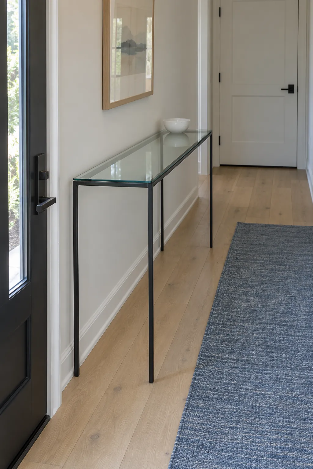 Glass console with clear floor sightlines and adjacent blue runner