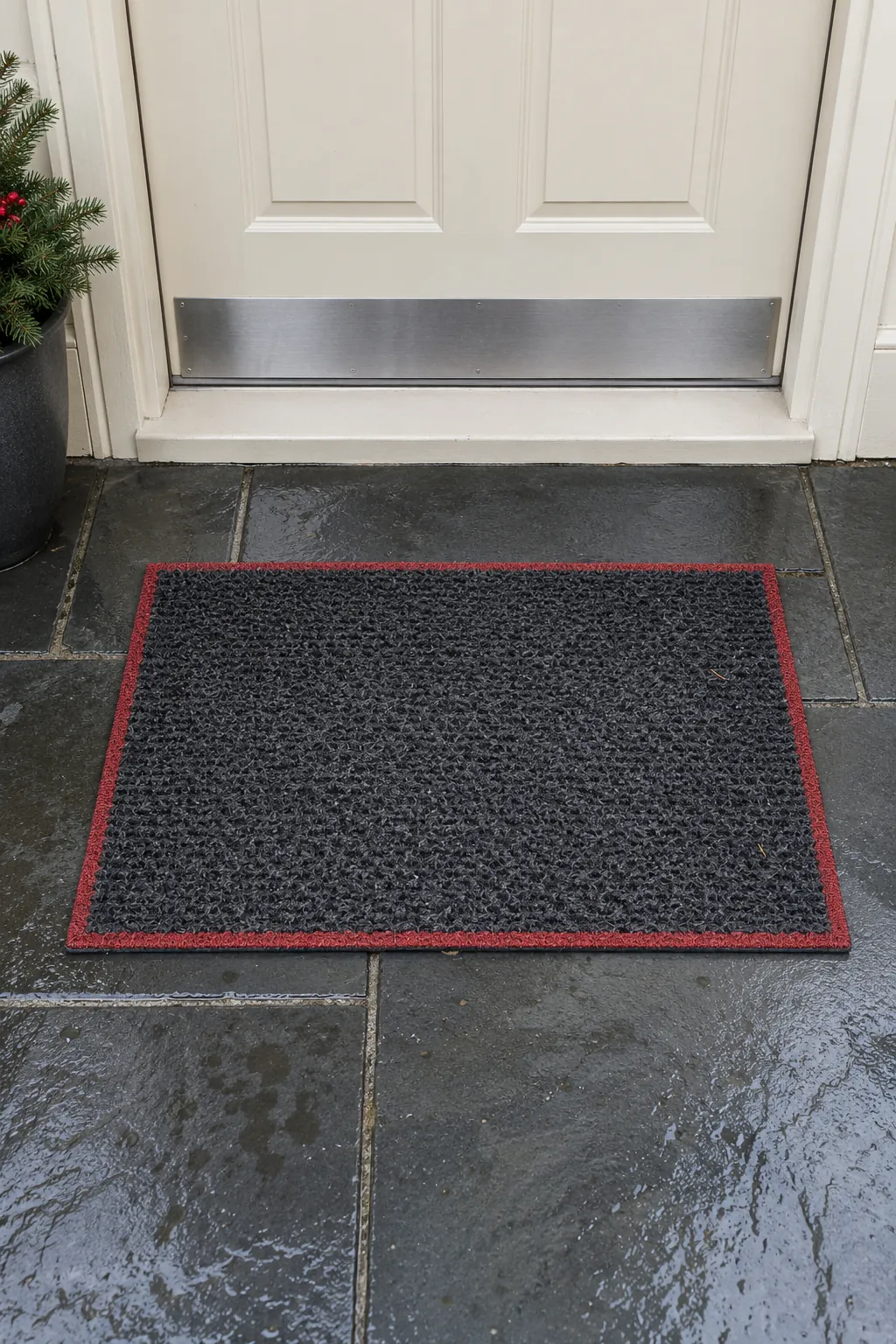 A plain outdoor mat with a festive border for a rain exposed Christmas entrance