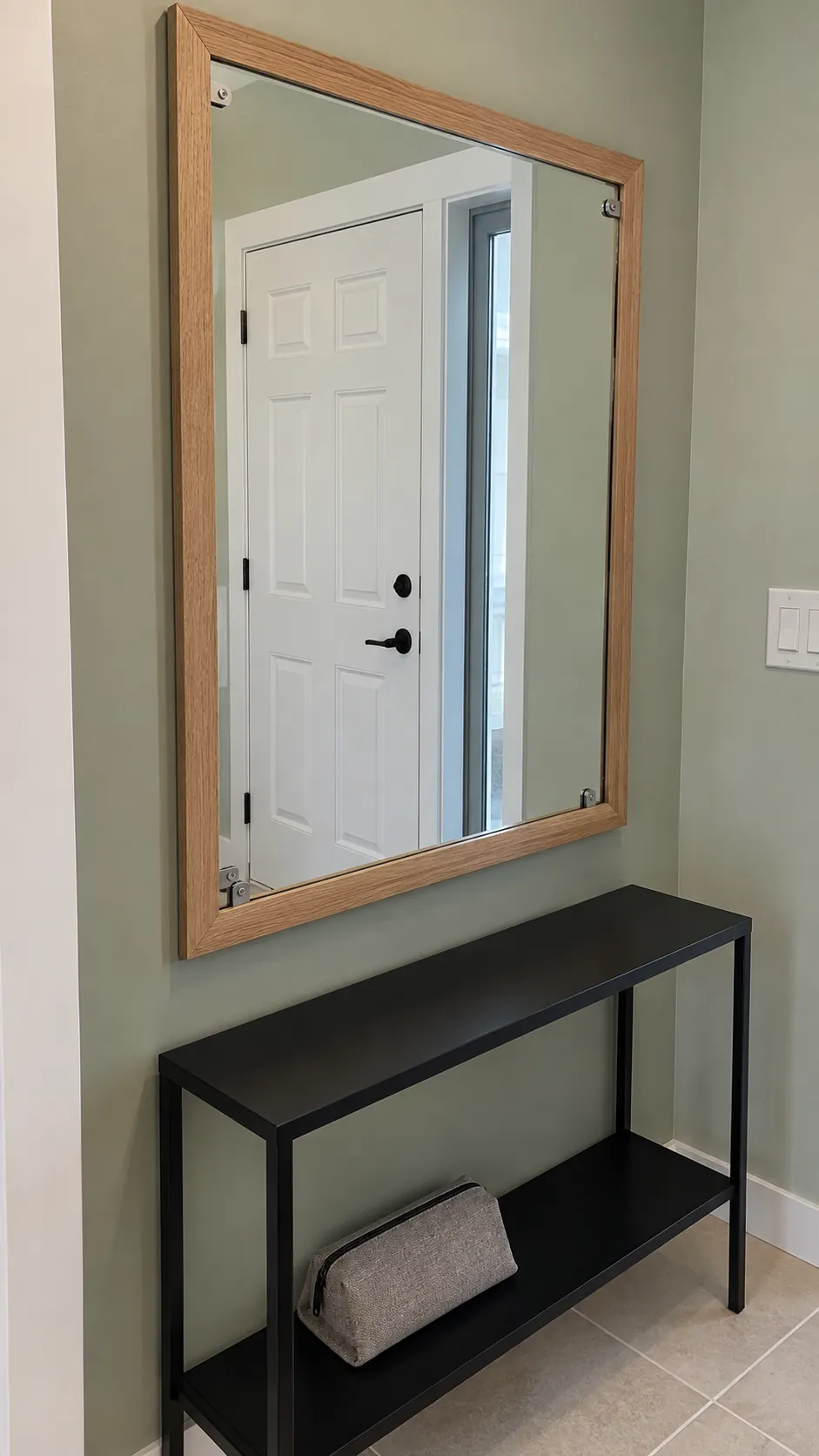 Add wood trim around a frameless mirror on an existing entryway mirror
