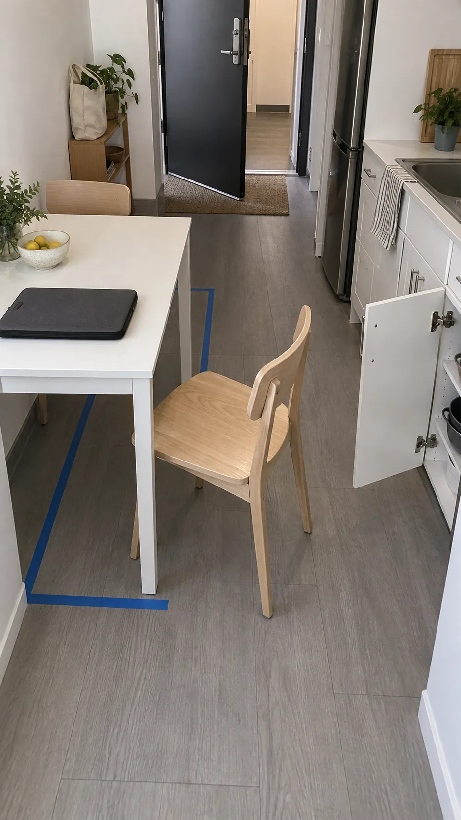 Small apartment dining table desk setup showing chair clearance in a small dining nook